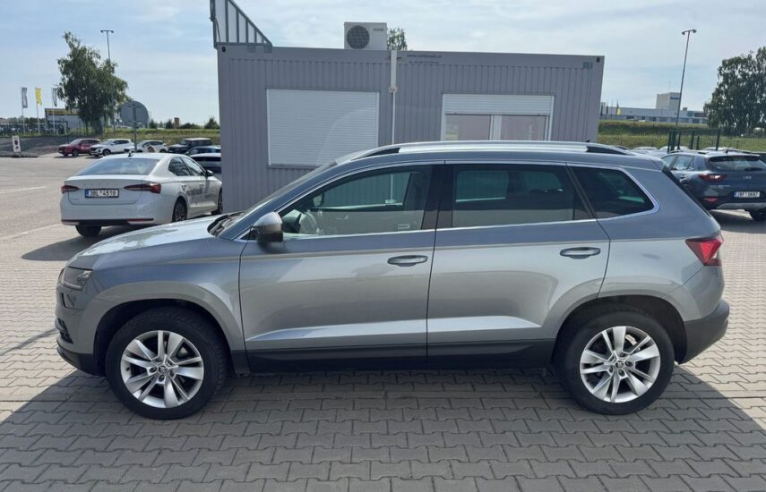 Stříbrná Škoda Karoq z boku se střešními ližinami